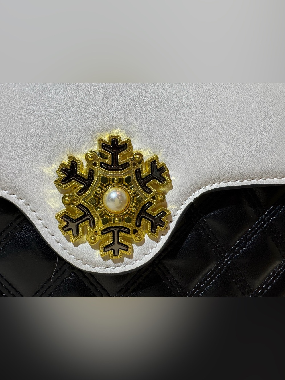White and Black Quilted Top-Handle Bag with Gold Emblem - Picture 9 of 11